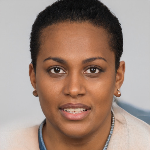 Joyful black young-adult female with short  brown hair and brown eyes