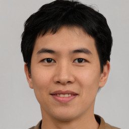 Joyful asian young-adult male with short  black hair and brown eyes