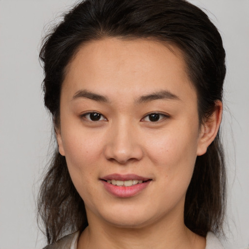 Joyful white young-adult female with medium  brown hair and brown eyes