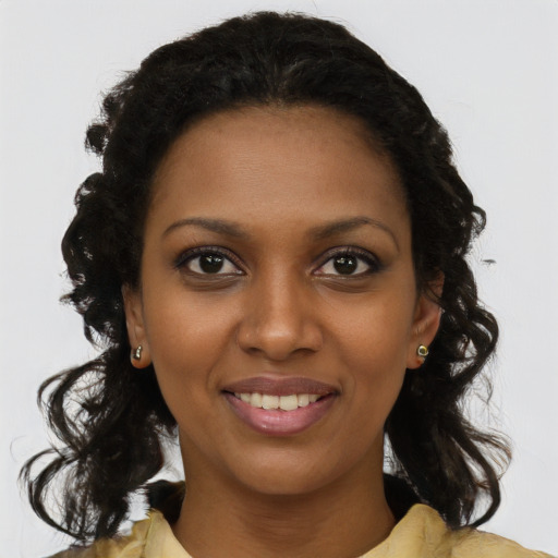 Joyful black young-adult female with medium  brown hair and brown eyes
