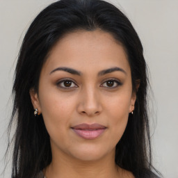 Joyful latino young-adult female with long  brown hair and brown eyes