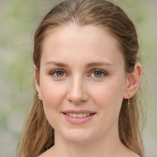 Joyful white young-adult female with medium  brown hair and green eyes