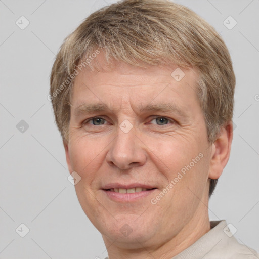 Joyful white adult male with short  brown hair and grey eyes