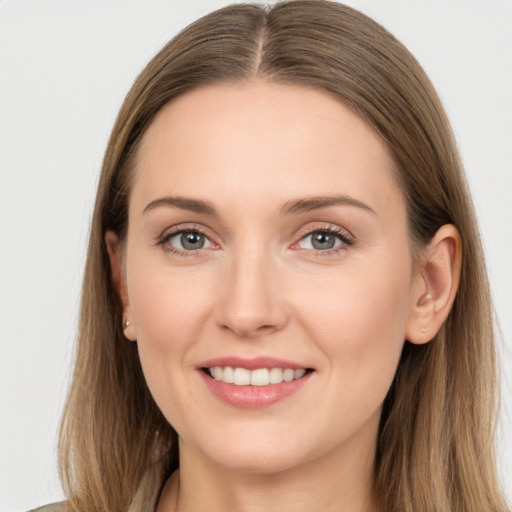 Joyful white young-adult female with long  brown hair and brown eyes