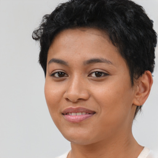 Joyful latino young-adult female with short  brown hair and brown eyes