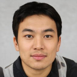 Joyful asian young-adult male with short  brown hair and brown eyes