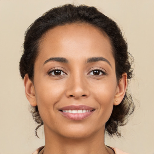 Joyful latino young-adult female with medium  brown hair and brown eyes