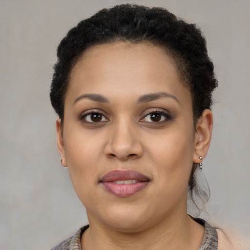 Joyful black young-adult female with short  brown hair and brown eyes