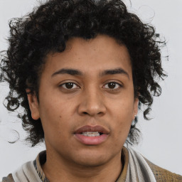 Joyful latino young-adult male with short  brown hair and brown eyes