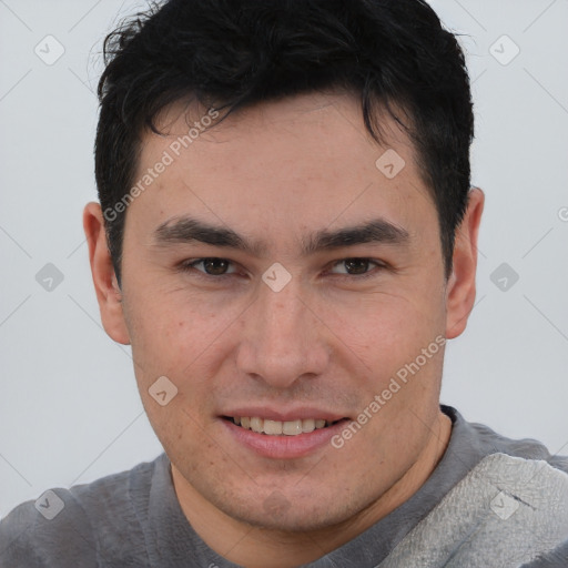 Joyful asian young-adult male with short  brown hair and brown eyes