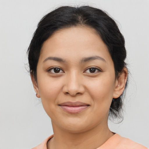 Joyful latino young-adult female with medium  brown hair and brown eyes