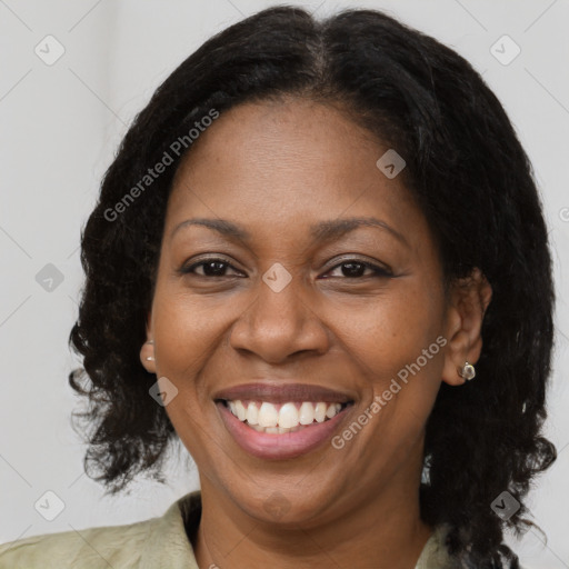 Joyful black adult female with medium  brown hair and brown eyes