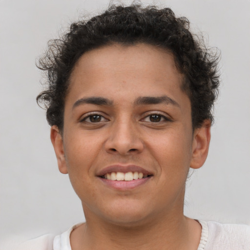 Joyful latino young-adult female with short  brown hair and brown eyes