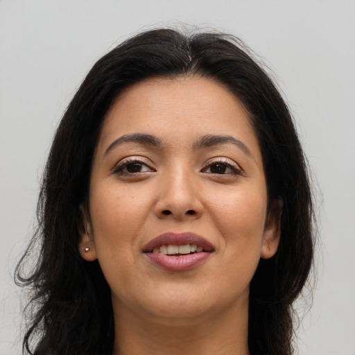 Joyful latino young-adult female with long  brown hair and brown eyes