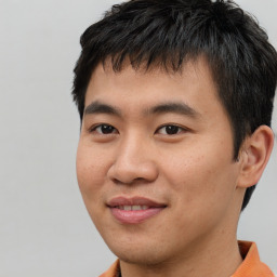 Joyful asian young-adult male with short  brown hair and brown eyes