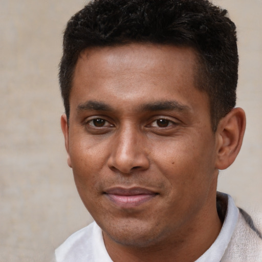 Joyful black young-adult male with short  black hair and brown eyes