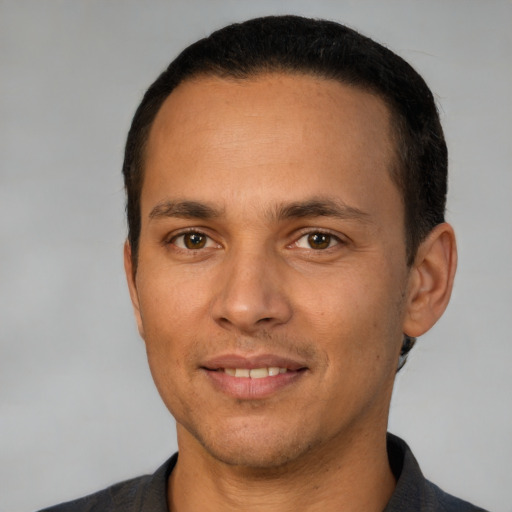 Joyful white adult male with short  brown hair and brown eyes