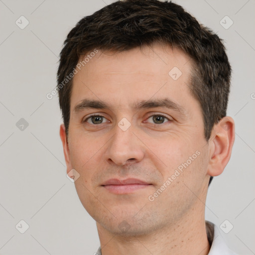 Joyful white young-adult male with short  brown hair and brown eyes