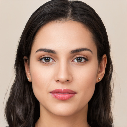 Joyful white young-adult female with long  brown hair and brown eyes