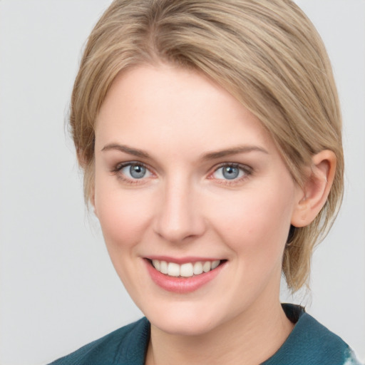 Joyful white young-adult female with medium  brown hair and blue eyes