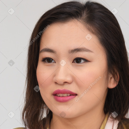 Joyful asian young-adult female with long  brown hair and brown eyes