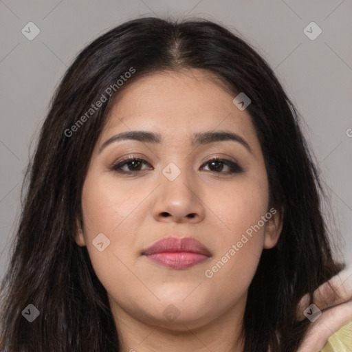 Joyful latino young-adult female with long  brown hair and brown eyes