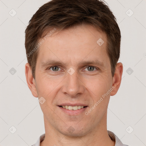 Joyful white adult male with short  brown hair and brown eyes