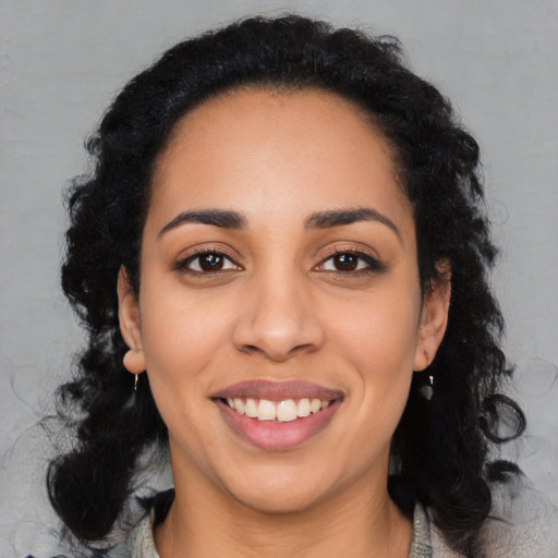 Joyful latino young-adult female with long  black hair and brown eyes