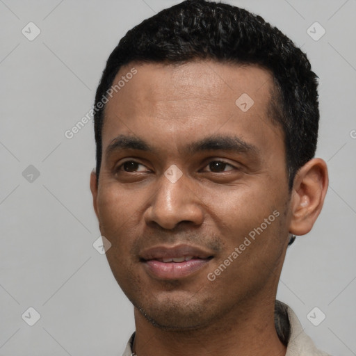 Joyful latino young-adult male with short  black hair and brown eyes