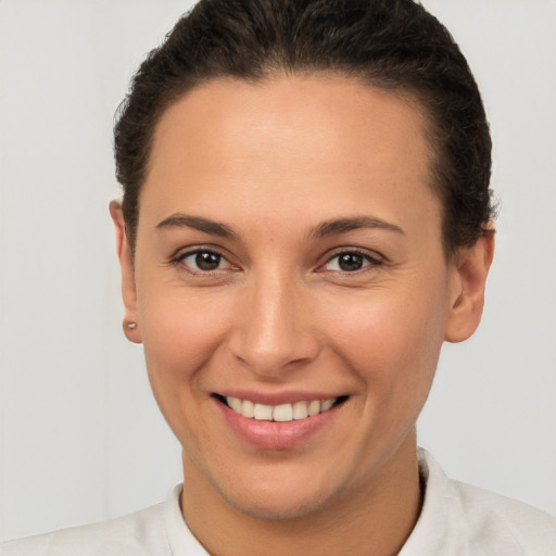 Joyful white young-adult female with short  brown hair and brown eyes