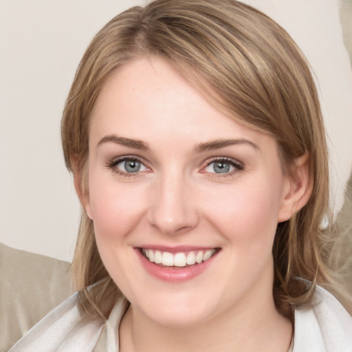 Joyful white young-adult female with medium  brown hair and blue eyes