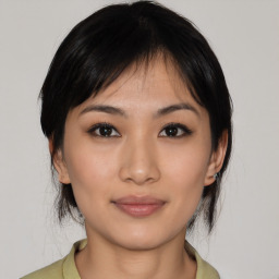 Joyful asian young-adult female with medium  black hair and brown eyes