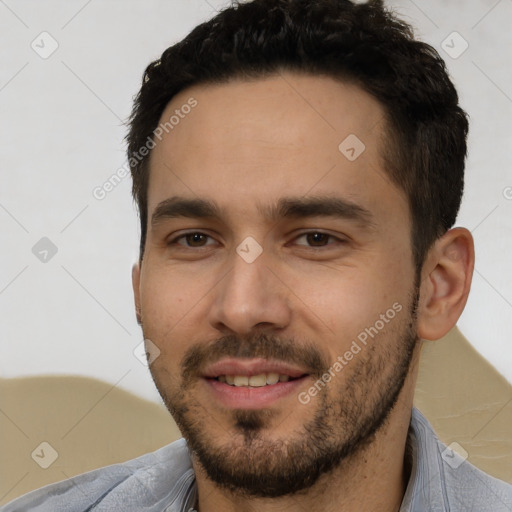 Joyful white young-adult male with short  black hair and brown eyes