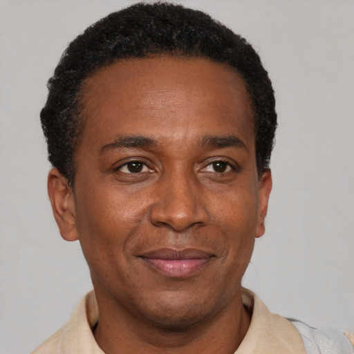 Joyful latino adult male with short  black hair and brown eyes