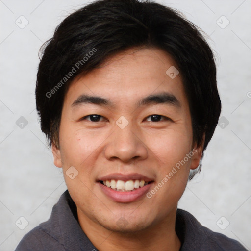 Joyful asian young-adult male with short  brown hair and brown eyes