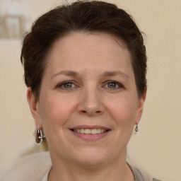 Joyful white adult female with short  brown hair and grey eyes