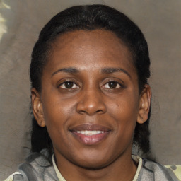 Joyful latino young-adult female with short  black hair and brown eyes