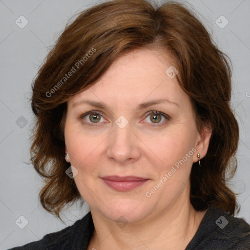 Joyful white adult female with medium  brown hair and blue eyes