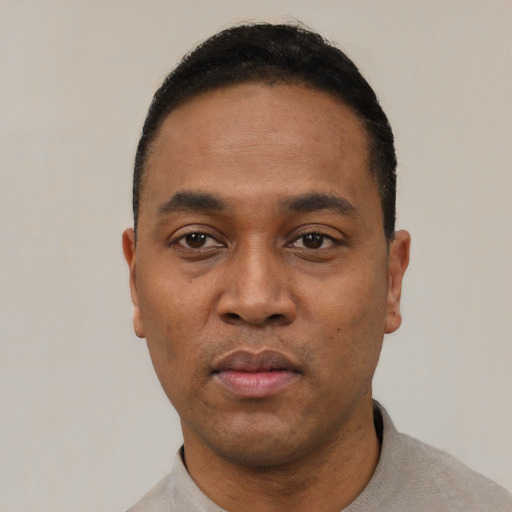 Neutral black young-adult male with short  black hair and brown eyes