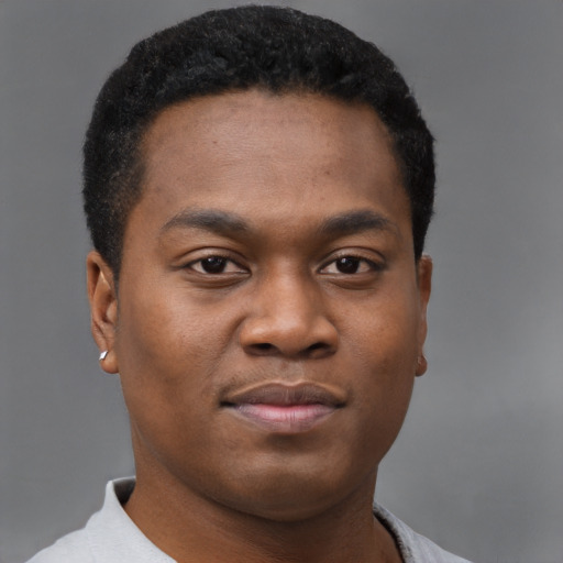 Joyful black young-adult male with short  brown hair and brown eyes