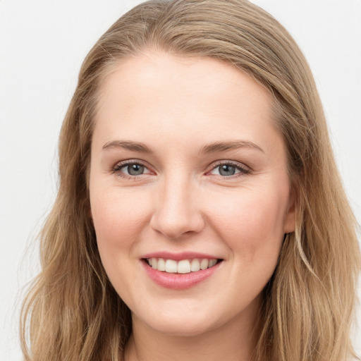 Joyful white young-adult female with long  brown hair and blue eyes