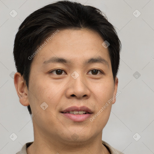 Joyful asian young-adult male with short  brown hair and brown eyes