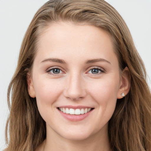 Joyful white young-adult female with long  brown hair and grey eyes