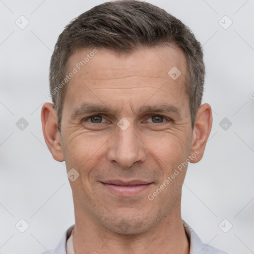 Joyful white adult male with short  brown hair and brown eyes