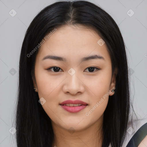 Joyful asian young-adult female with long  black hair and brown eyes