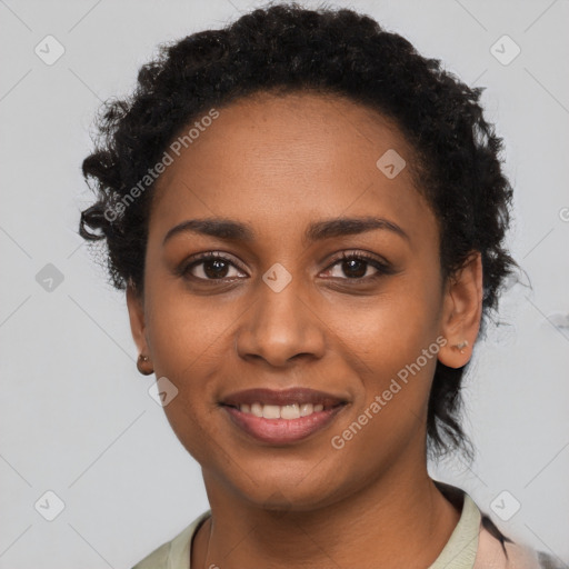 Joyful black young-adult female with short  black hair and brown eyes