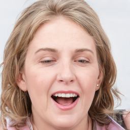 Joyful white young-adult female with long  brown hair and blue eyes