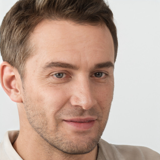 Joyful white adult male with short  brown hair and brown eyes