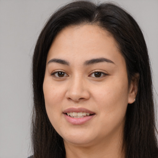 Joyful asian young-adult female with long  brown hair and brown eyes
