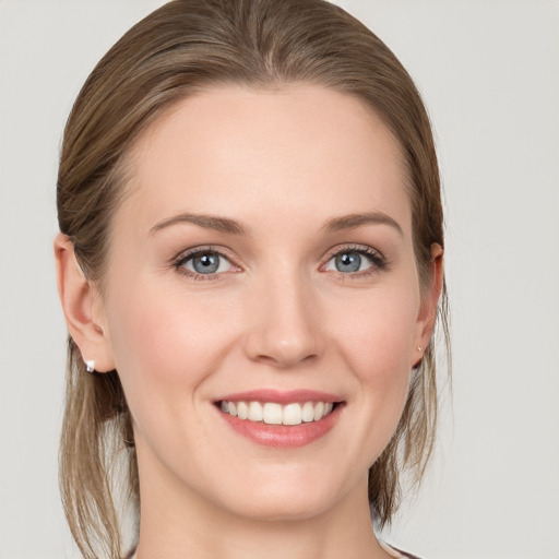 Joyful white young-adult female with medium  brown hair and blue eyes